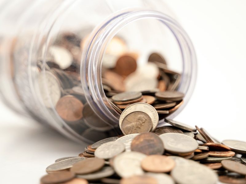 Jar with coins falling out
