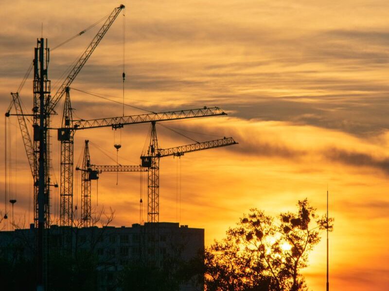Sunset with cranes and building